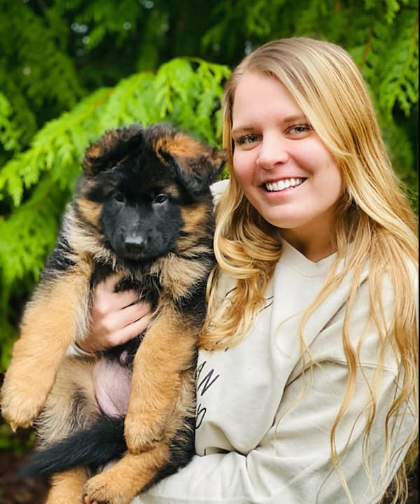 Young Woman With Her New Long Coat Puppy